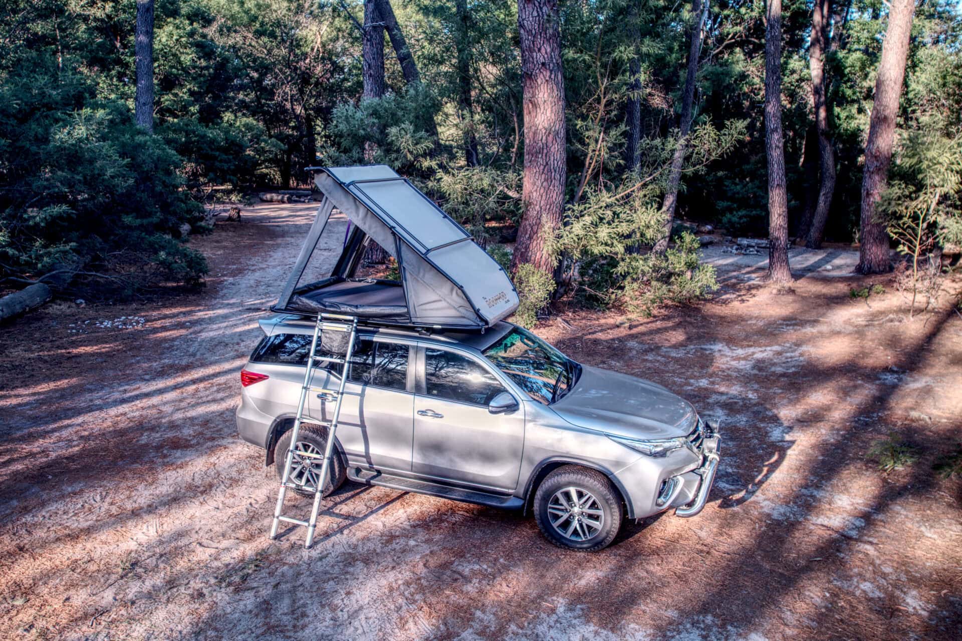 Streamlined rooftop tent car setup with a lightweight roofpod, ideal for outdoor adventures.